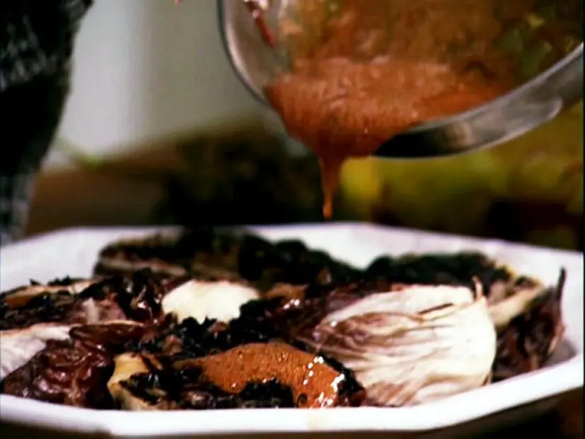 Grilled Radicchio and Pickled Shallots being drizzled with a Honey Dressing