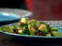 Brussel Sprouts with Bacon and Parmesan on a blue, black and white plate