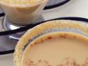 A Close-up of two Glasses of Butterscotch Bliss between a meandering blue ribbon