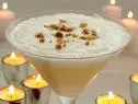 The Wedding Dress in a long stem glass surrounded by lite candles 