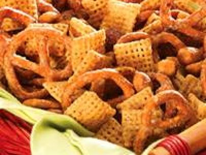 Nutty Snack Mix on a light green cloth in a red wicker basket
