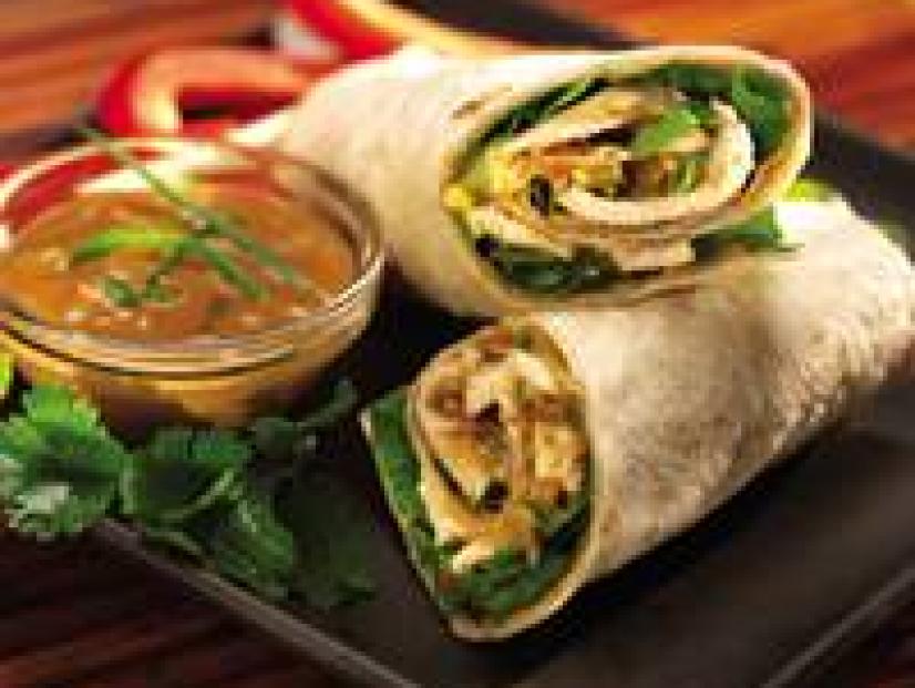 Thai Peanut Butter Chicken Wraps ona plate with dipping sauce