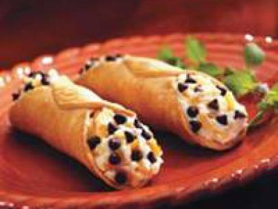 Two Citrus Cannolis on a Decorative Red plate 