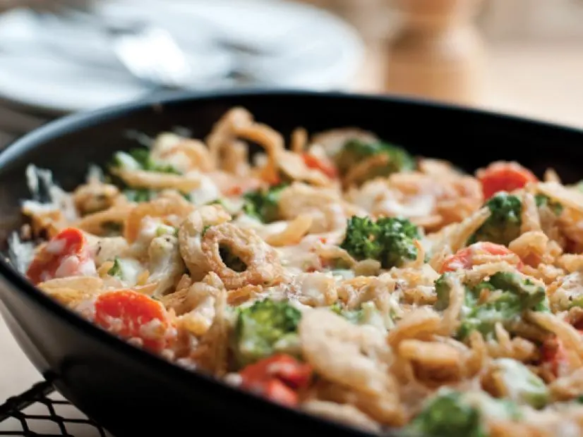 Vegetable Casserole in a black skillet placed on a cooling rack