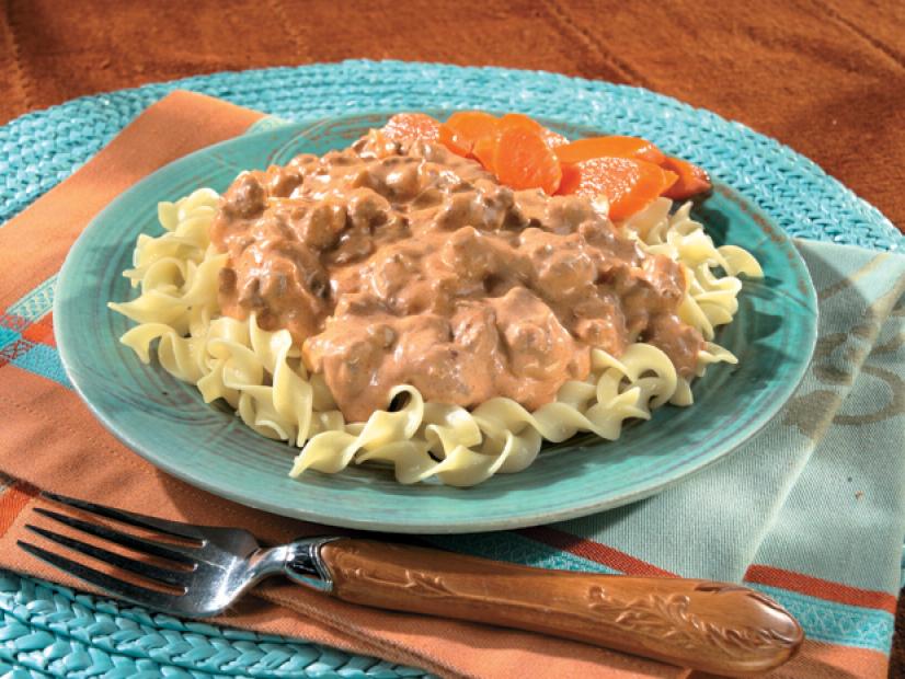 Mexican Stroganoff with sliced carrots on a green blue plate