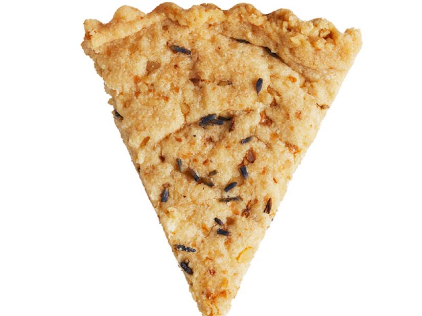 A walnut Shortbread cookie sprinkled with lavendar and shaped like a slice of pizza