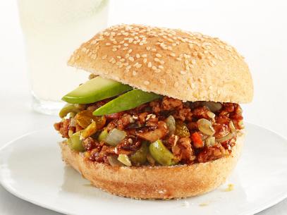 Loose meat turkey mixed with a variety of vegetables between  a seasame seed bun
