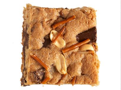A Square Cookie with nuts, chocolate chunks and pretzels