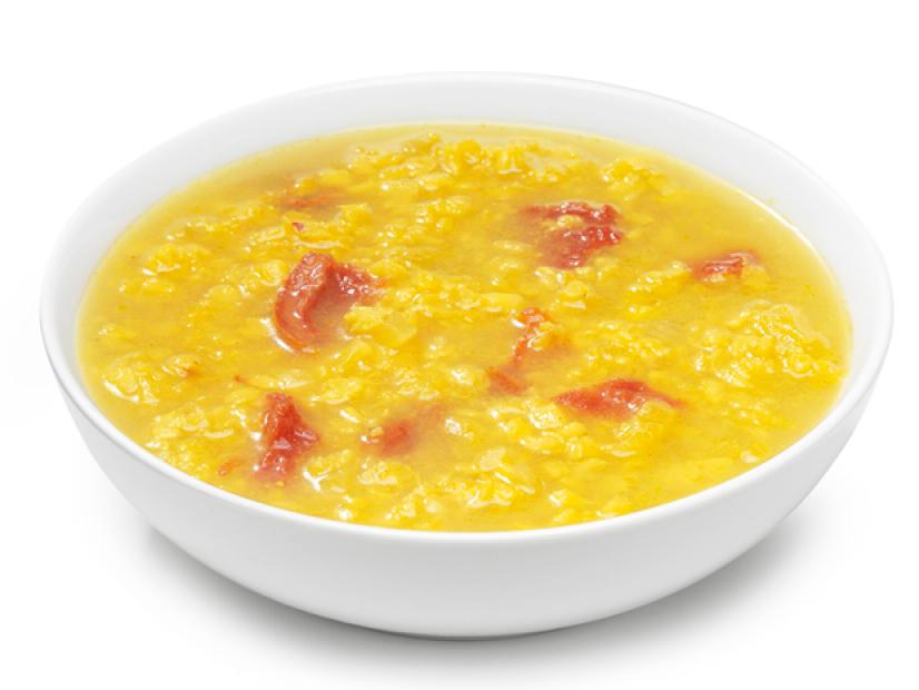 A Yellow and Red Soup in a Plain White Bowl