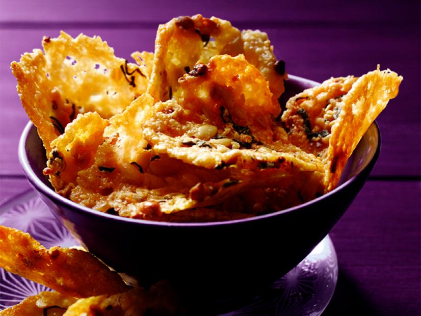 Crispy chips as a main appetizer in a bowl against a purple background