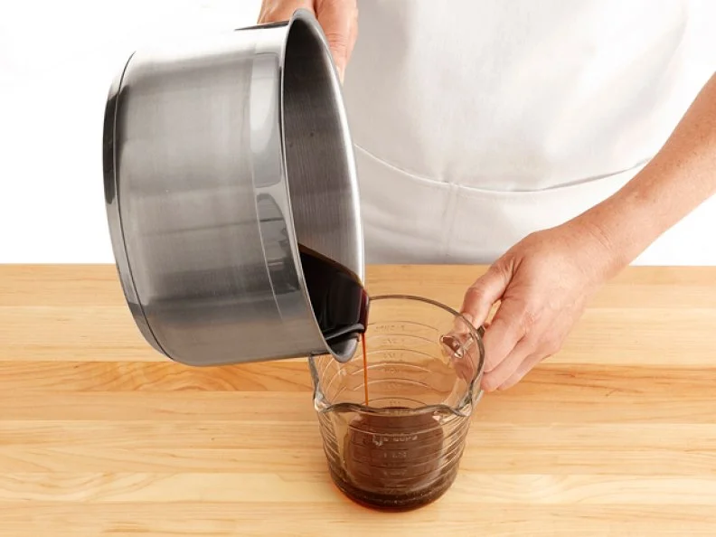 Pouring Caramel from a Sauce Pan into a Measuring Cup