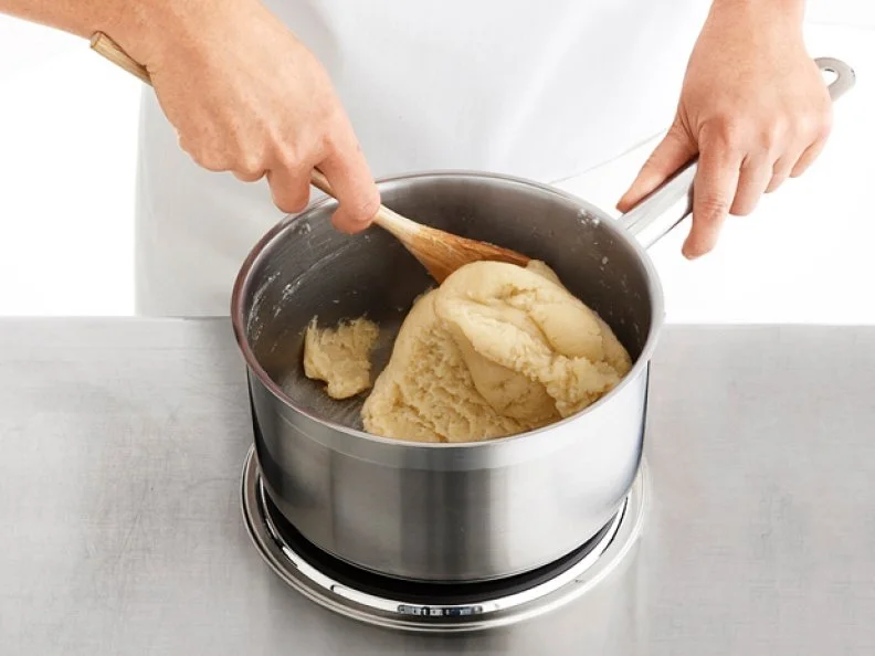 Blending the Pastry Dough in a Sauce Pan with a Wooden Mixing Spoon
