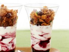 Two Parfaits in Tall Glasses on a Green Table Cloth