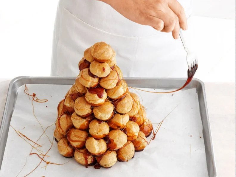Pastries Stacked to a Peak With Caramel Oozing Out and Drizzled over it