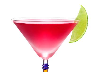 A Peach Cosmo Cocktail Garnished With a Slice of Lime in a Long Stemmed Glass 