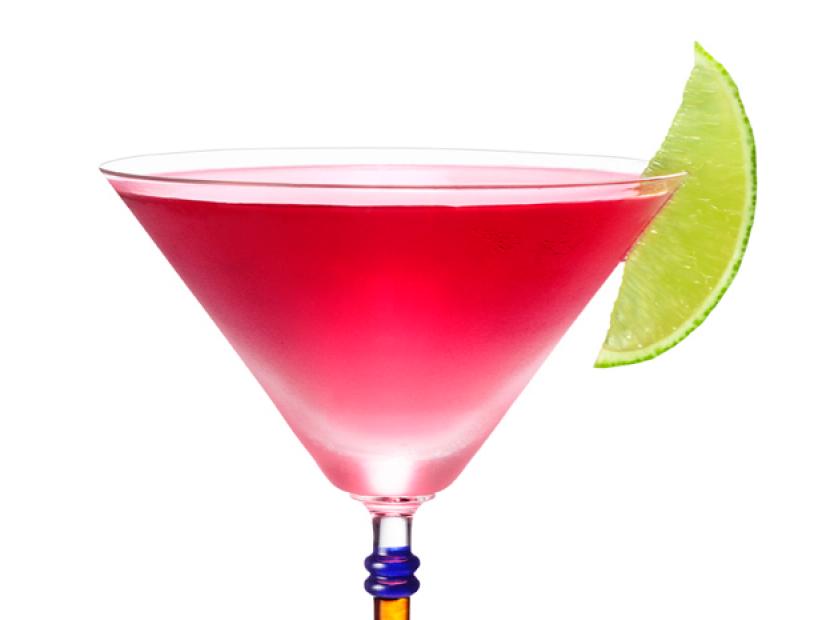 A Peach Cosmo Cocktail Garnished With a Slice of Lime in a Long Stemmed Glass 