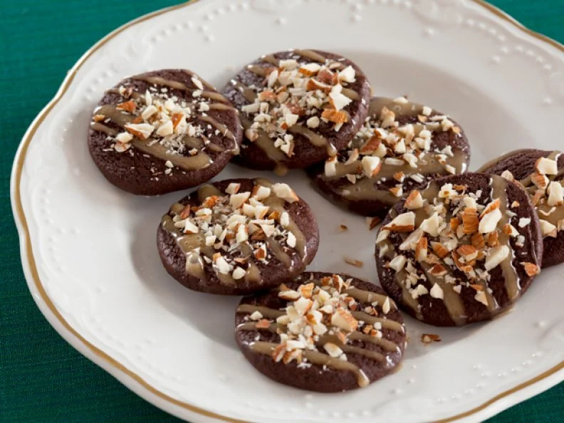 Aaron Sanchezs Cinnamon Hot Spiced Chocolate Cookies on a decoratrive white plate trimmed in gold