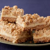 Oatmeal Cream Cheese Butterscotch Bars on a green plate against a purple background