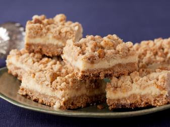 Oatmeal Cream Cheese Butterscotch Bars on a green plate against a purple background