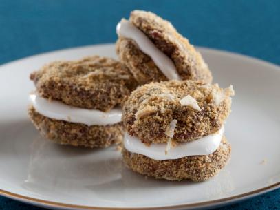 Three Crunchy Peanut Smore Bites on a white plate trimmed in gold