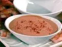 Chili Mayo Cocktail Sauce in a white bowl placed near uncooked shrimp