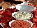 Horseradish Cocktail Sauce aligned with two other cocktail dishes on a tray full of shrimp