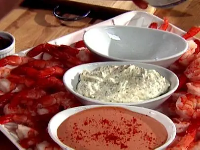 Horseradish Cocktail Sauce aligned with two other cocktail dishes on a tray full of shrimp