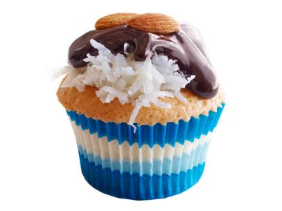 A cupcake with Candy Bar toppings in a white and blue cupcake wrapper