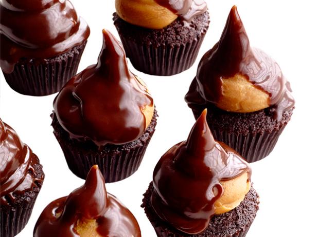 Mini Chocolate Cupcakes in brown cupcake wrappers topped with Reeses toppings