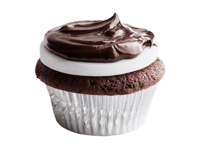 A mini chocolate cupcake in a silver cupcake wrapper topped with Peppermint and chocolate