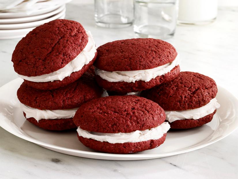 Round red cookies with cream sandwiched between them