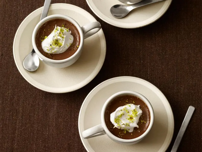 Cups of coffee in coffee cups with a whipped topping on top