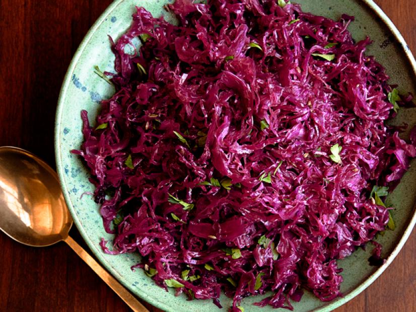 A red cabbage slaw in a green bowl