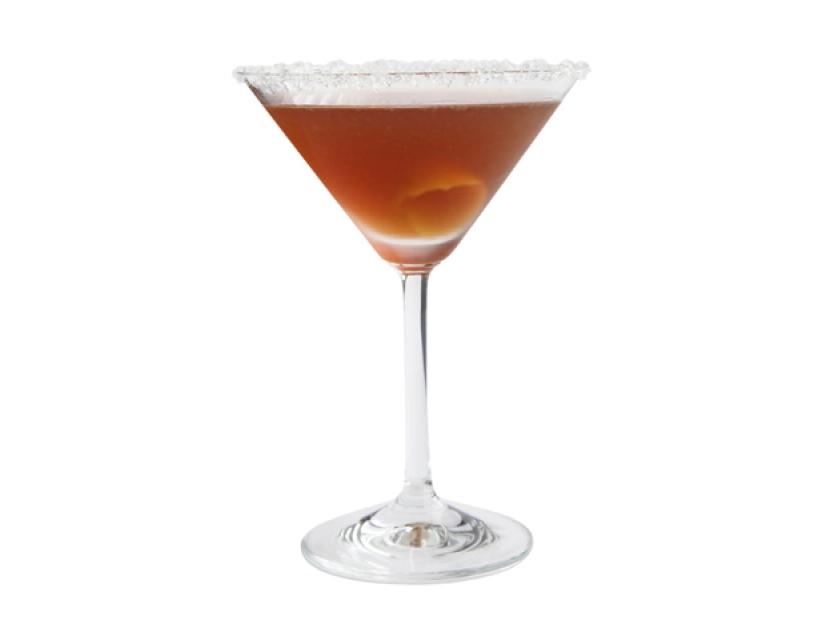 A dark brown drink in a martini glass