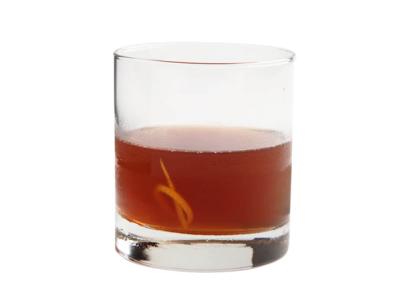 A dark brown drink in a short glass