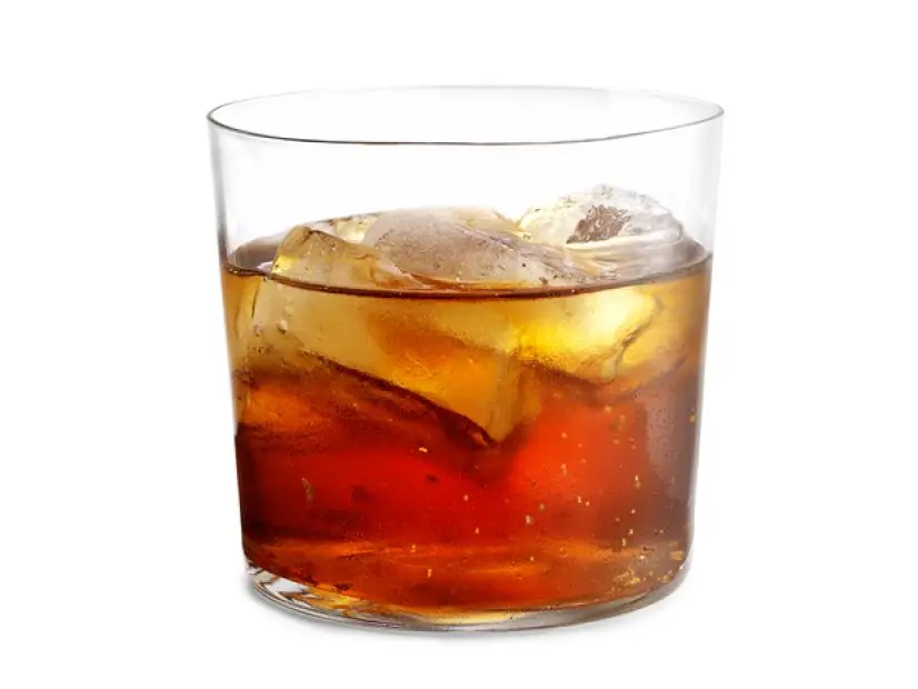 A drink with ice in a short glass