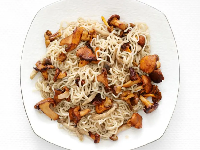Mixture of mushrooms and ramen noodles on a white plate