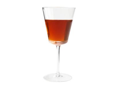 a dark brown drink in a long stemmed glass