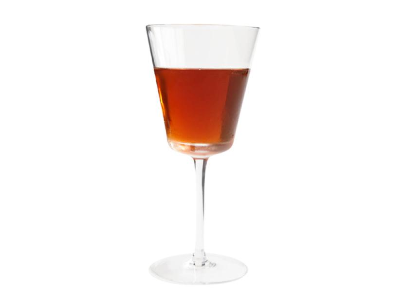 a dark brown drink in a long stemmed glass