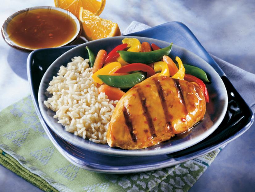 Asian Grilled Chicken on a blue plate with rice and sliced peppers