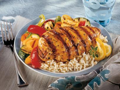 Grilled Chicken Breast and Vegetables on a bed of rice in a blue and white bowl