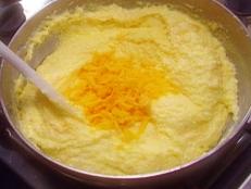 For a simple side dish, try Alton Brown's Savory Polenta recipe from Good Eats on Food Network; minced garlic and grated Parmesan add real savory depth.
