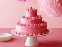 BIRTHDAY CAKE WITH HOT PINK BUTTER ICINGIna GartenBarefoot Contessa/Kids Picnic PartyFood NetworkUnsalted Butter, Sugar, Eggs, Sour Cream, Vanilla Extract, Lemon, AllpurposeFlour,Cornstarch, Kosher Salt, Baking Soda, Confectionersâ   Sugar, Milk, Pink Food Coloring, Pink andWhite Candy