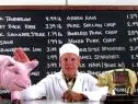 Alton Brown with pigs and chalkboard.