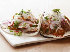 Serve Bobby Flay's healthy Fish Tacos recipe, from Boy Meets Grill on Food Network, with a fresh tomato salsa at your next party.