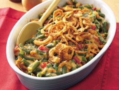 Green Bean Casserole topped with French Fried Onions in a blue and white dish