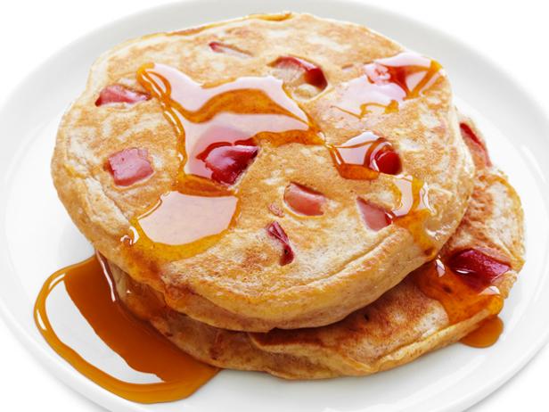 Stack of Apple Pancakes with Syrup on a White Plate