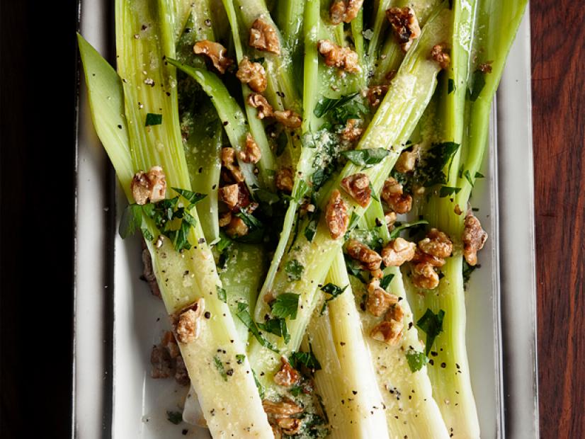 Dish of Leeks, Nuts and Vinaigrette on a Wooden Table