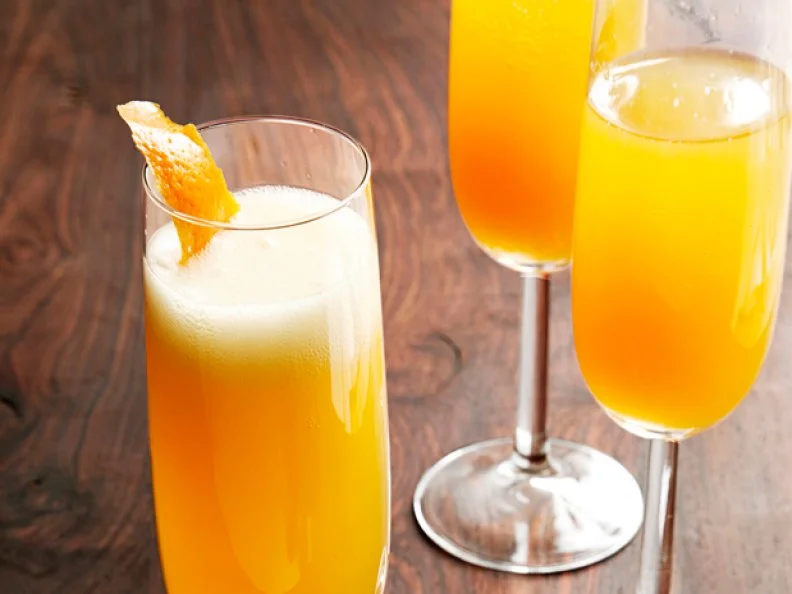 Three Glasses of a Champagne Cocktail in Stemware on a Wooden Surface