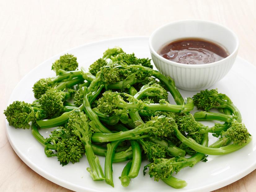 Baby Broccoli with Sauce on a White Dish